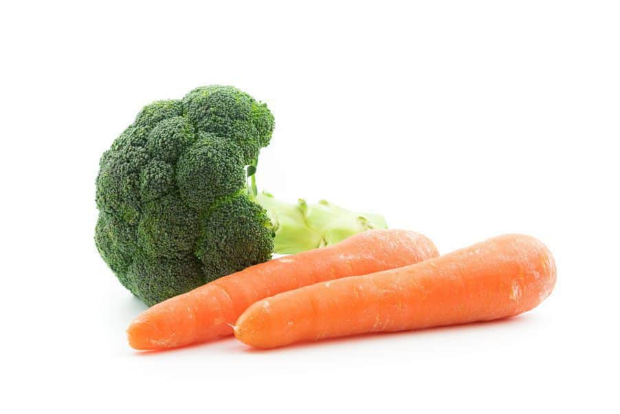 carrots Fresh broccoli and two carrots on a white background.