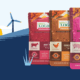 Row of colorful Logic tea boxes arranged in front of a stylized landscape with hills, wind turbines, and a yellow sun.