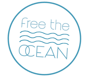 freeocean-logo Circular badge with light blue text that reads "free the OCEAN" and three wavy lines between the words.