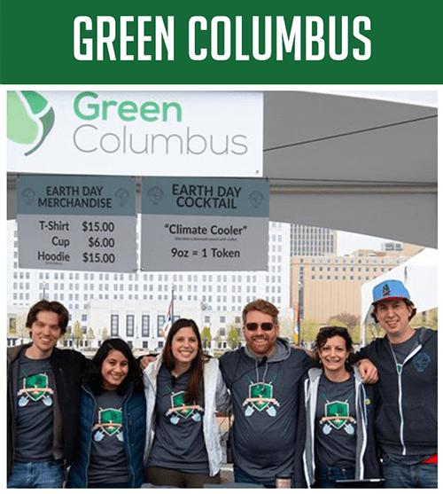 green-col3 Six people wearing matching gray shirts pose in front of a Green Columbus Earth Day booth.