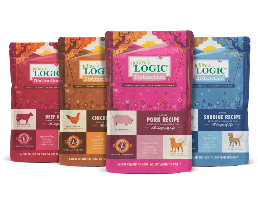 Distinction Dog Family Shot Red, orange, pink & blue bags of Nature's Logic Distinction beef, chicken, pork, & sardine recipes.